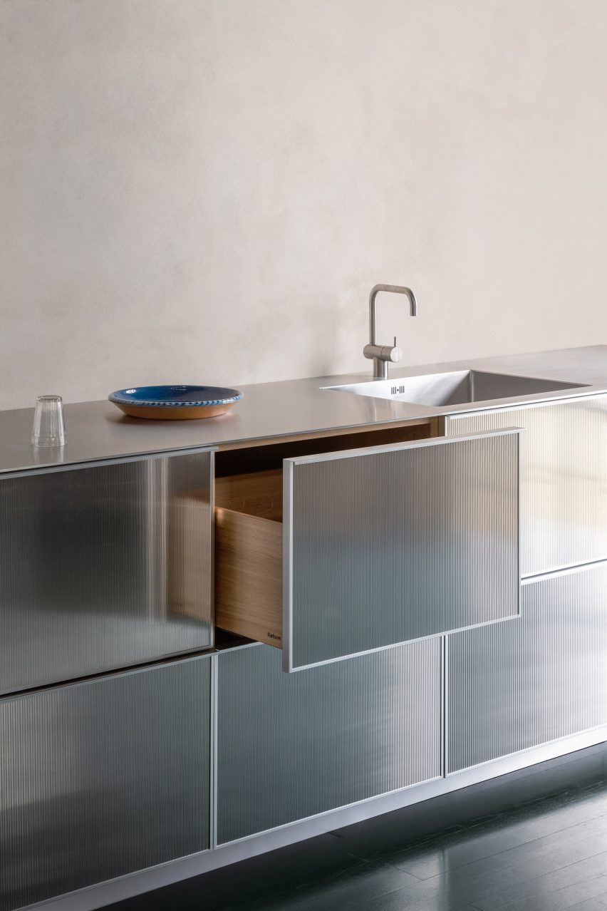 A photograph of a kitchen that reflects light
