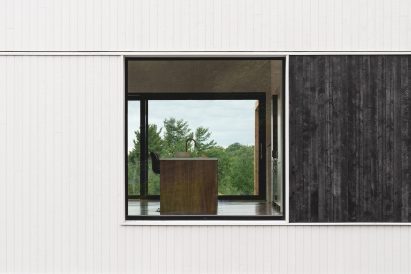 White wood exterior with burnt cedar panel