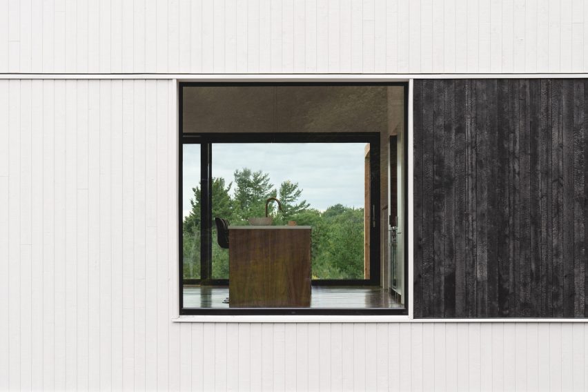 White wood exterior with burnt cedar panel