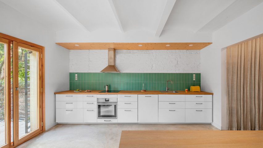 The kitchen has a white interior