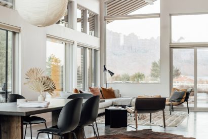 Inside the house by Studio Upwall Architects there are white walls and a pitched ceiling brings a feeling of lightness and space