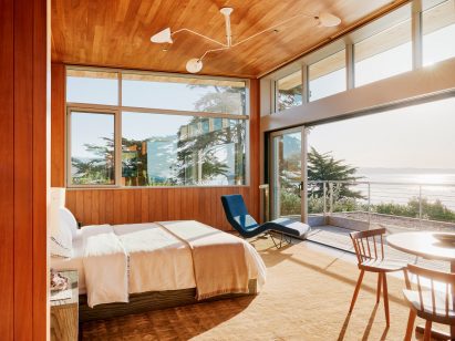 Throughout the dwelling, rooms are adorned with earthy materials and contemporary decor