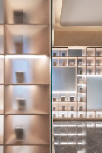 A bookcase covered in frosted glass inside The Glade Bookstore