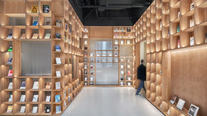 Wooden bookshelves line The Glade Bookstore by HAS Design and Research