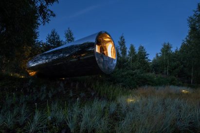 Tube houses by Sergey Kuznetsov at night with spot lights illuminating the surroundings
