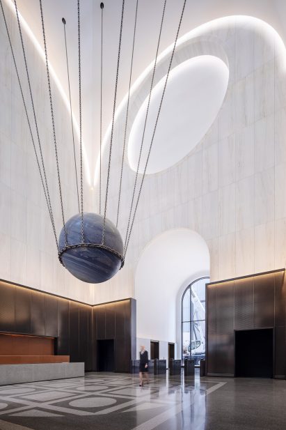 The lobby has a triple-height vaulted ceiling