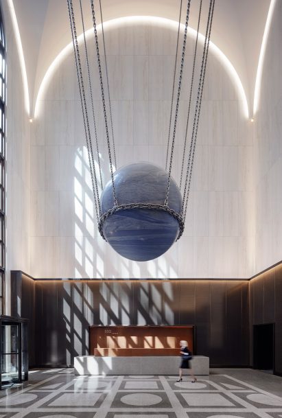 Light filters through the window onto the marble walls of 550 Madison