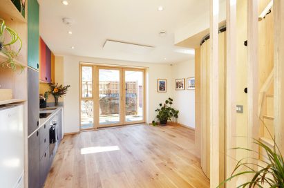 A photograph of a kitchen with wooden flooring