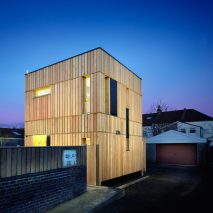 A photograph of a square wooden building