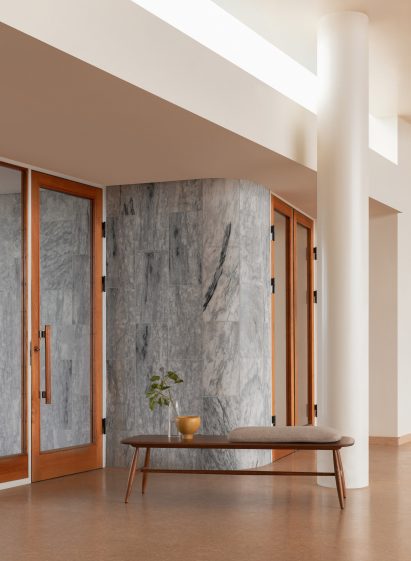 Low wooden bench holding a vase