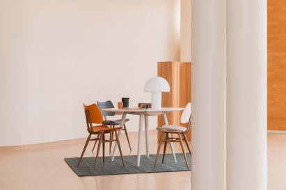 Desk setup with wooden chairs lacquered in red and blue