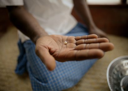 A photograph of a person holding a pearl