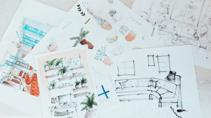 Top view of sketches on paper laying on a surface