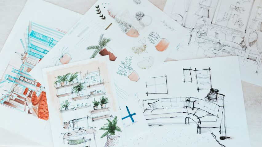 Top view of sketches on paper laying on a surface
