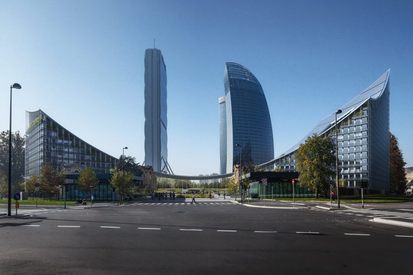Two mid-rise buildings joined by a low swooping roof with towers rising in the background