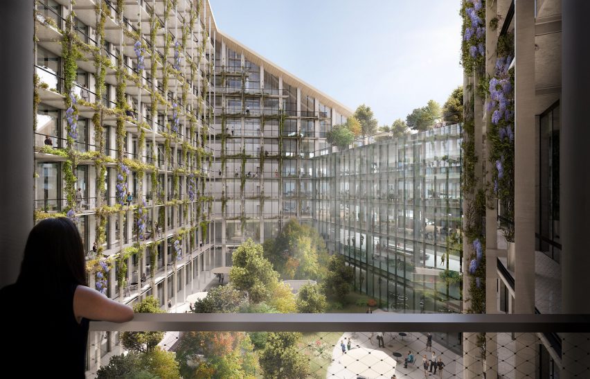a person stands on the balcony overlooking an internal courtyard within the CityWave building