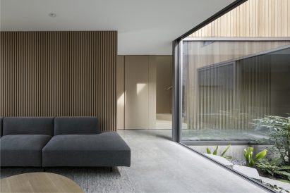 A living room with large window that looks onto a courtyard