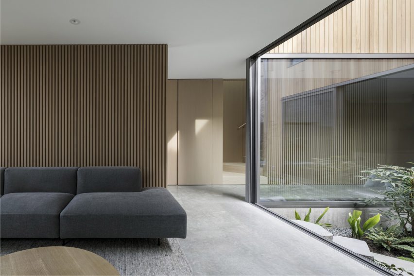 A living room with large window that looks onto a courtyard