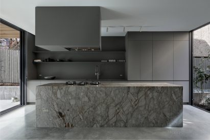 A grey kitchen inside Courtyard House