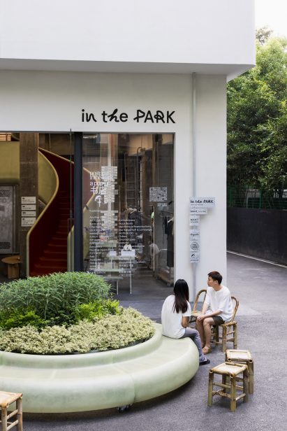 A couple sit outside the shop In the Park