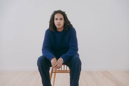 Mac Collins sitting on a wooden chair