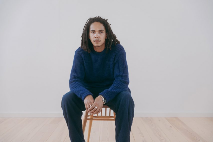 Mac Collins sitting on a wooden chair
