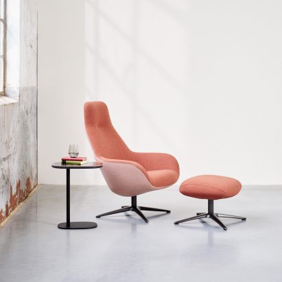 A pink high-backed LXR03 chair and footstool