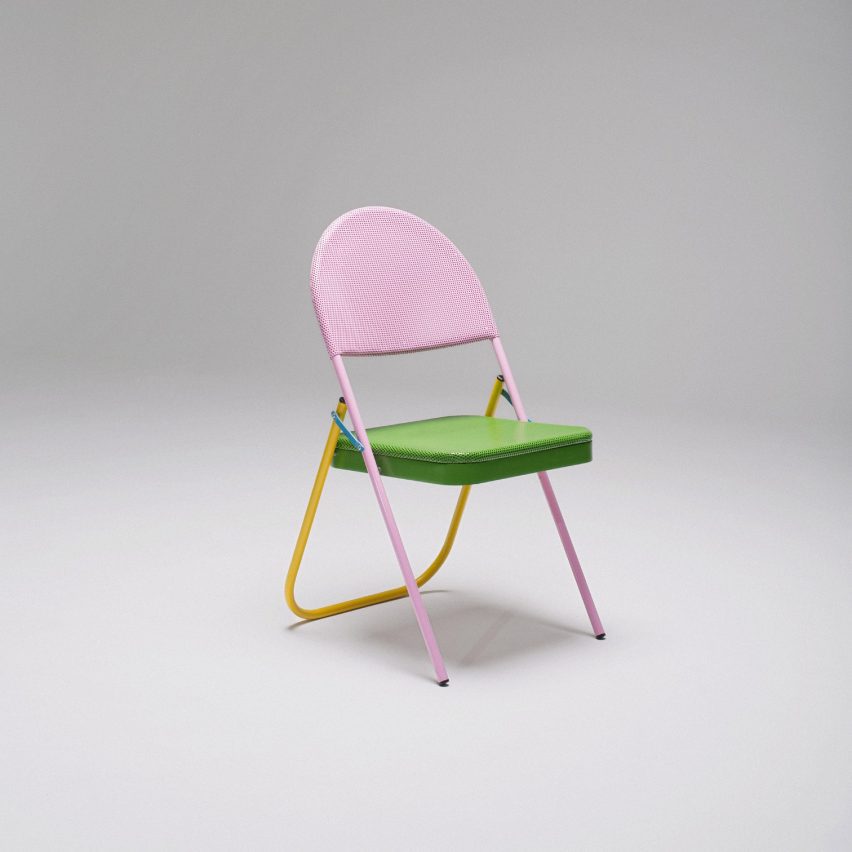 Folding metal chair with candy pink frame, one yellow leg and bright green seat