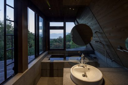 The bathroom is enveloped by windows