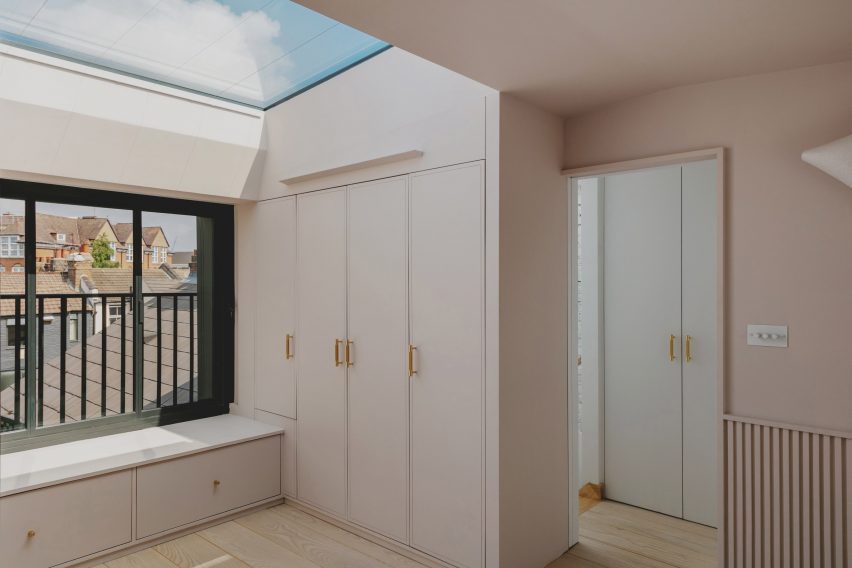 Dressing area in Bed and window in Narford Road loft extension by Emil Eve Architects