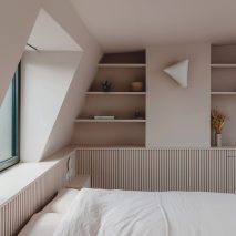 Bed and window in Narford Road loft extension by Emil Eve Architects