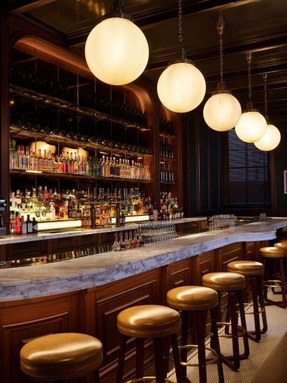 Wood-fronted bar with marble top in NoMad London hotel