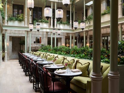 Planting trough and green bench seating in hotel interior by Roman and Williams