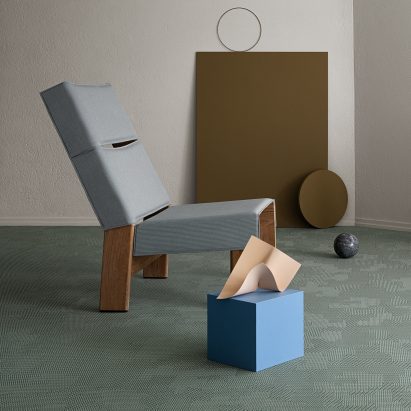 A blue chair on a turquise floor by Bolon