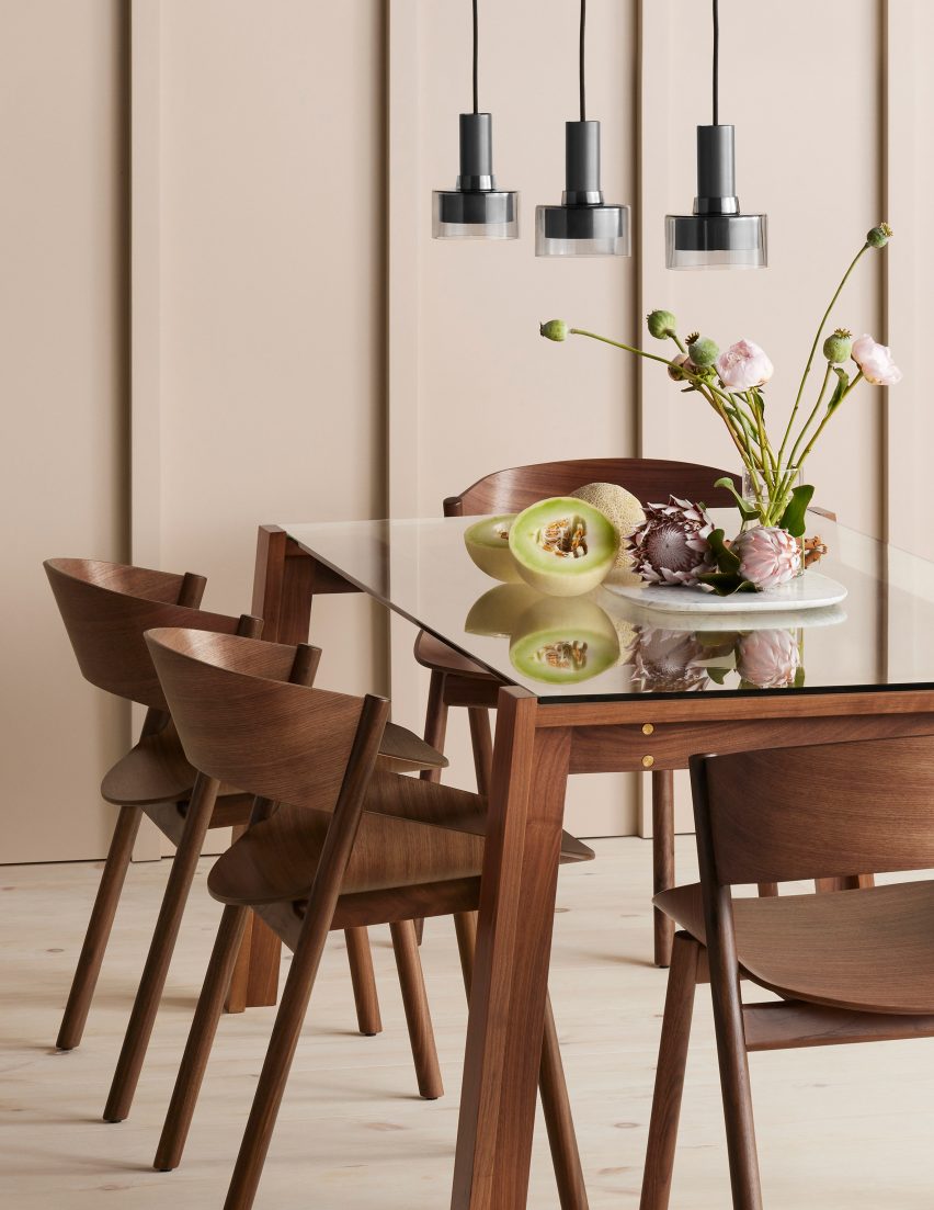 Several Port dining chairs in walnut wood around a dining table