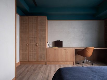 Bedroom with teal ceiling and wooden furniture in Residence W
