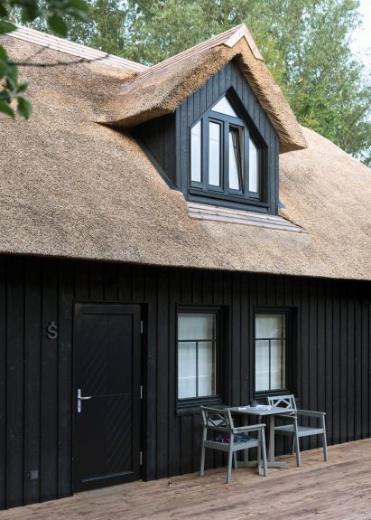 The exterior of the building was clad in charred timber and has a thatched roof