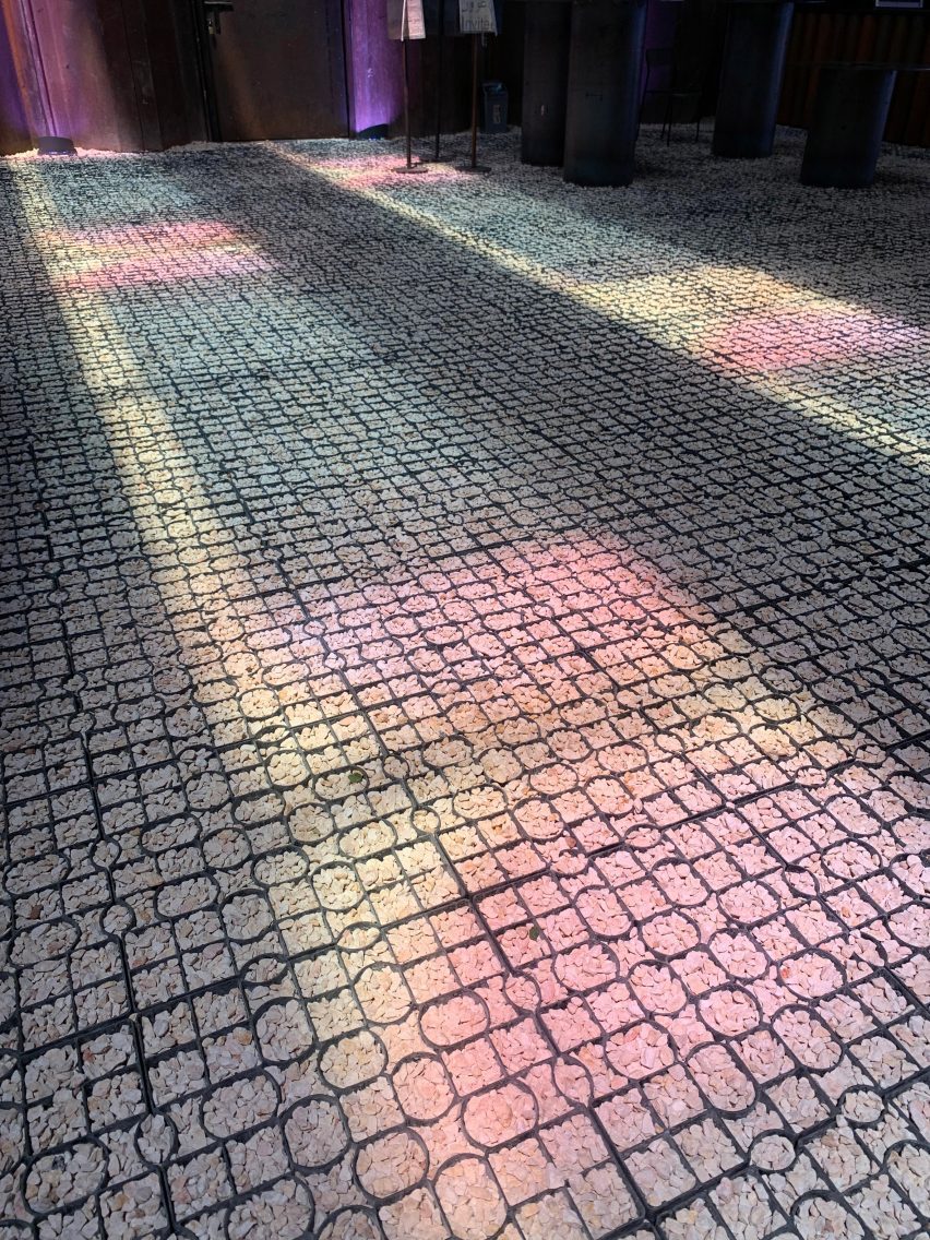 Pink, blue and yellow light on a pebble floor