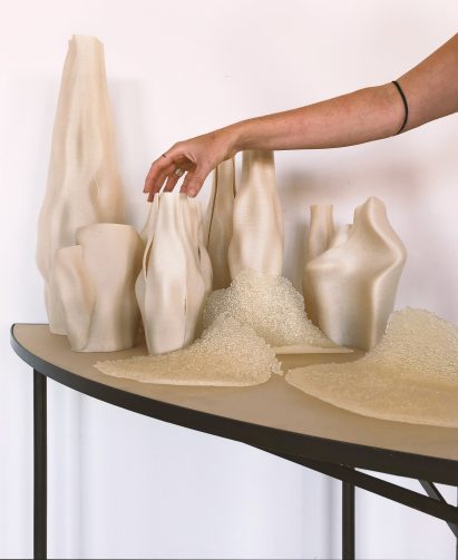 Vases are organised in a collection beside the chargers