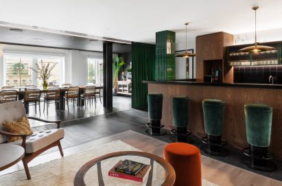 A bar area is adjoined to a large meeting table