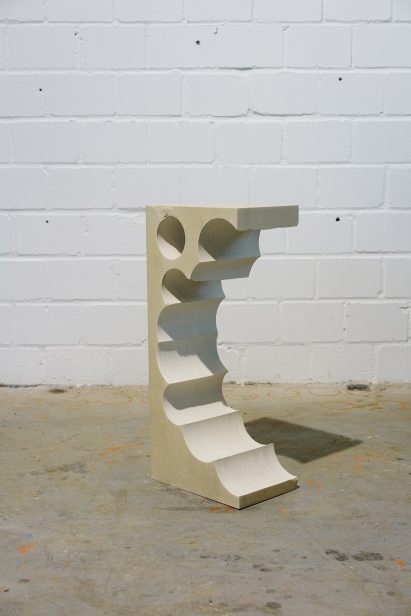 Teil 1 tall limestone side table with cylindrical shapes extracted from one side