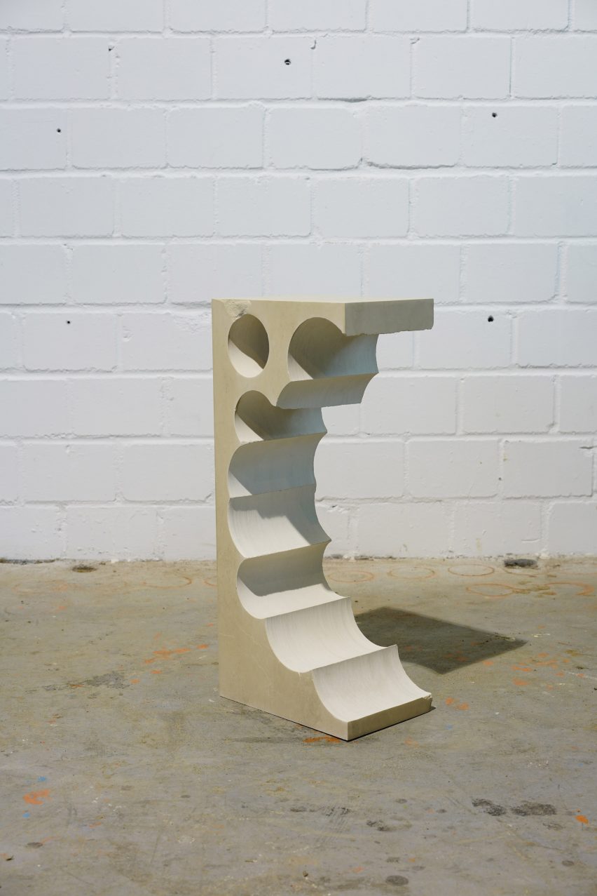 Teil 1 tall limestone side table with cylindrical shapes extracted from one side
