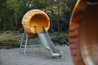 A wooden sphere with a metal slide