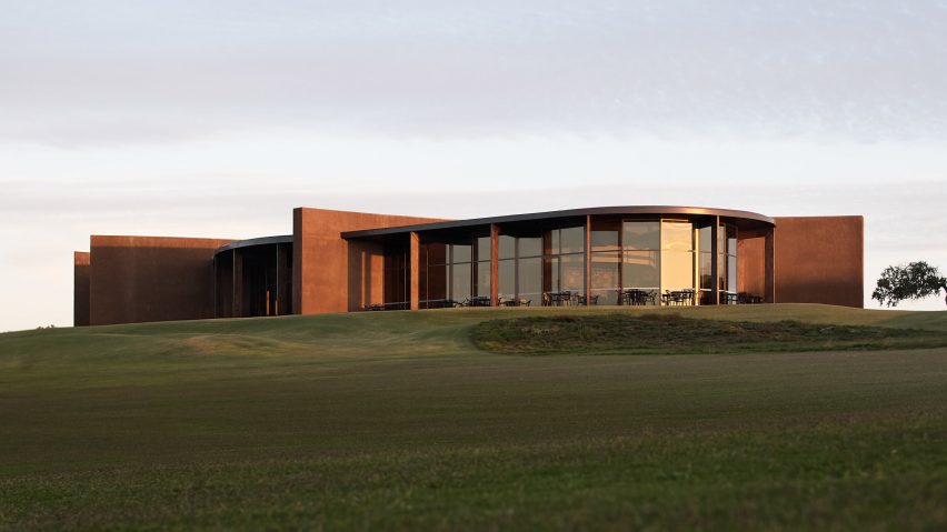 The clubhouse is pictured on top of a hill