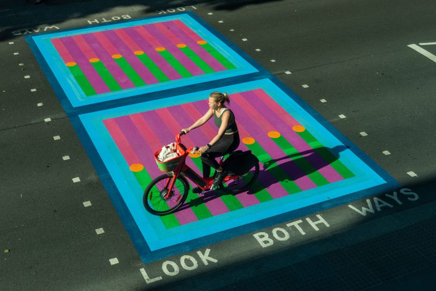 Cyclist riding over Yinka Ilori crossings for Bring London Together