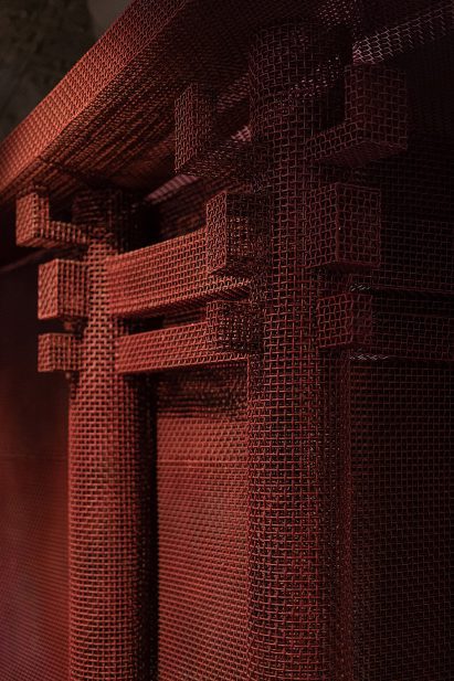 Red metal mesh was shaped into architectural forms