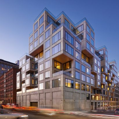 Facade of a residential building with stacked concrete and glass cubic volumes