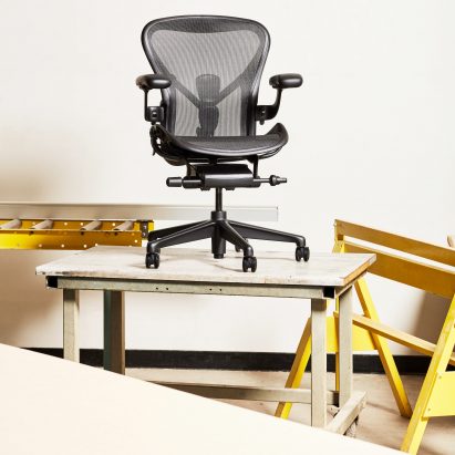 A black Aeron chair by Herman Miller on a desk