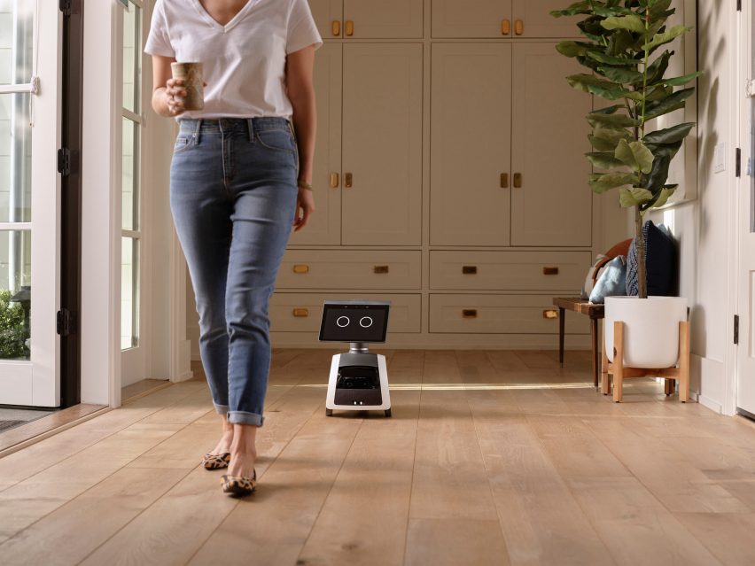 Astro robot following a woman around the house