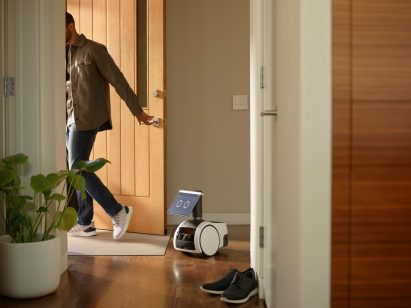 Astro robot and a man shutting a door